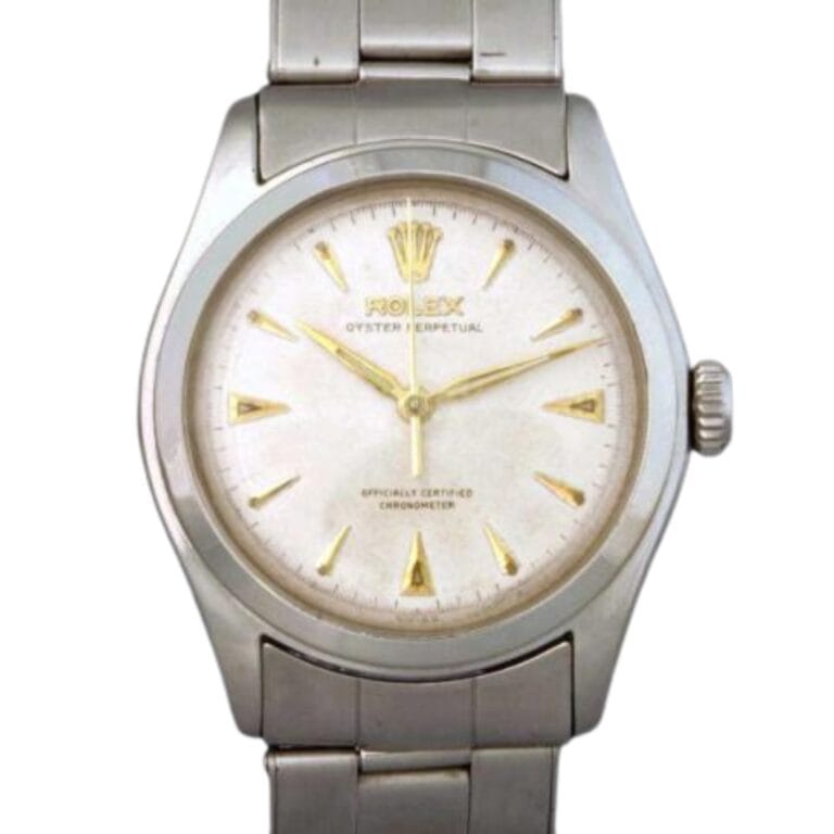 A silver Rolex Oyster Perpetual 6106 watch with a white dial and gold hour markers.