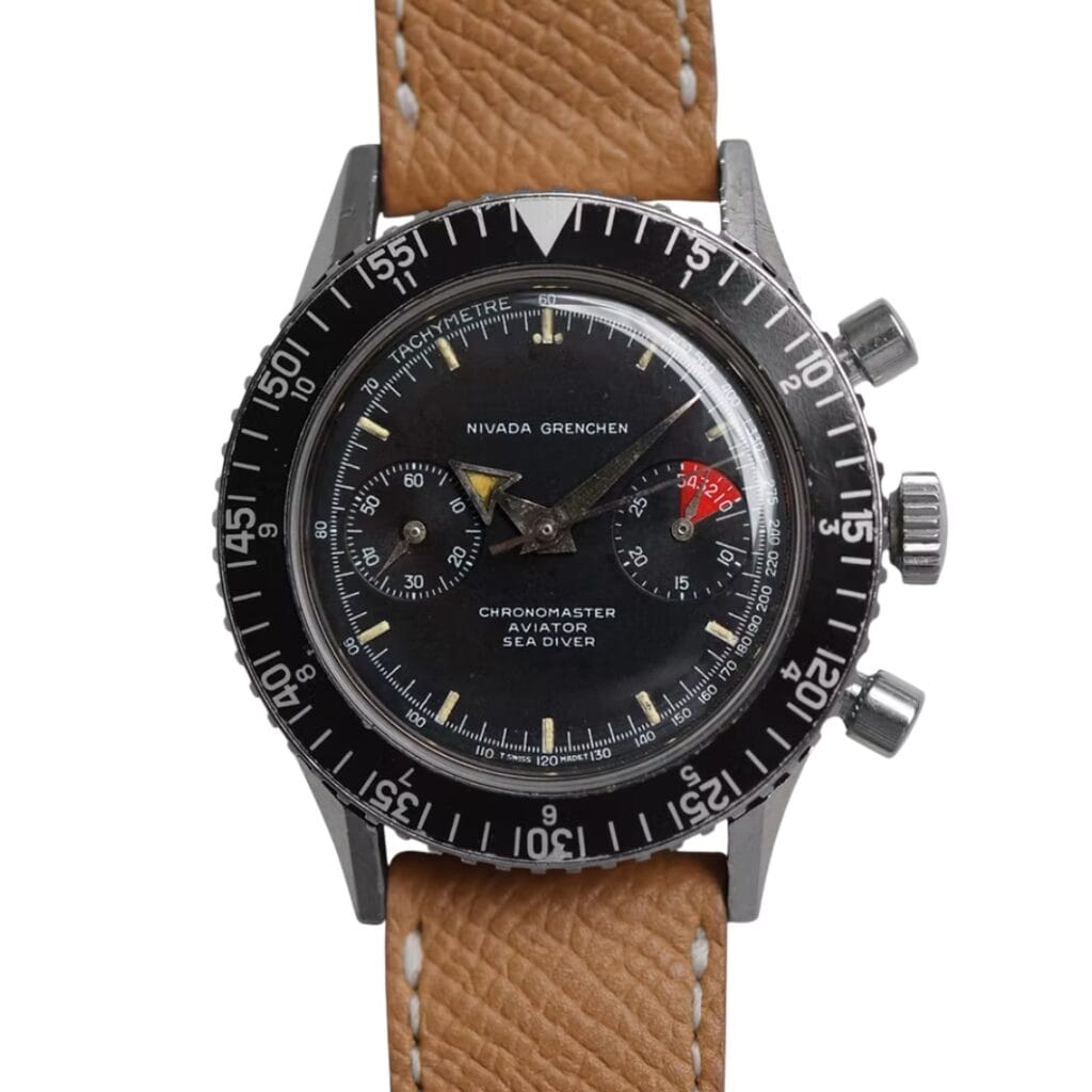 A vintage Nivada Grenchen Chronomaster Aviator Sea Diver watch featuring a black dial and tan leather strap.