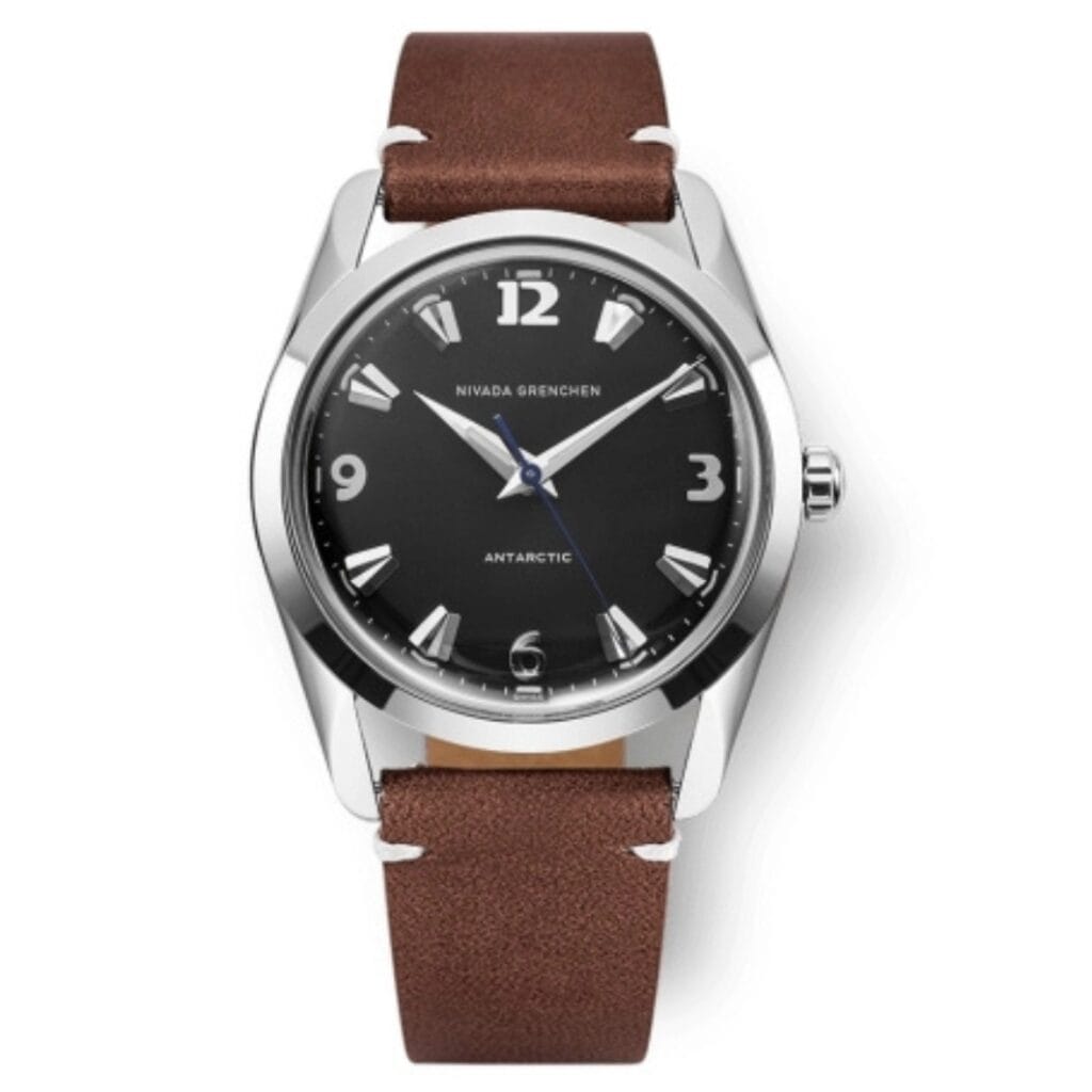 A Nivada Grenchen Antarctic 35002M14 wristwatch with a brown leather strap and a black dial displaying the time 10:10.