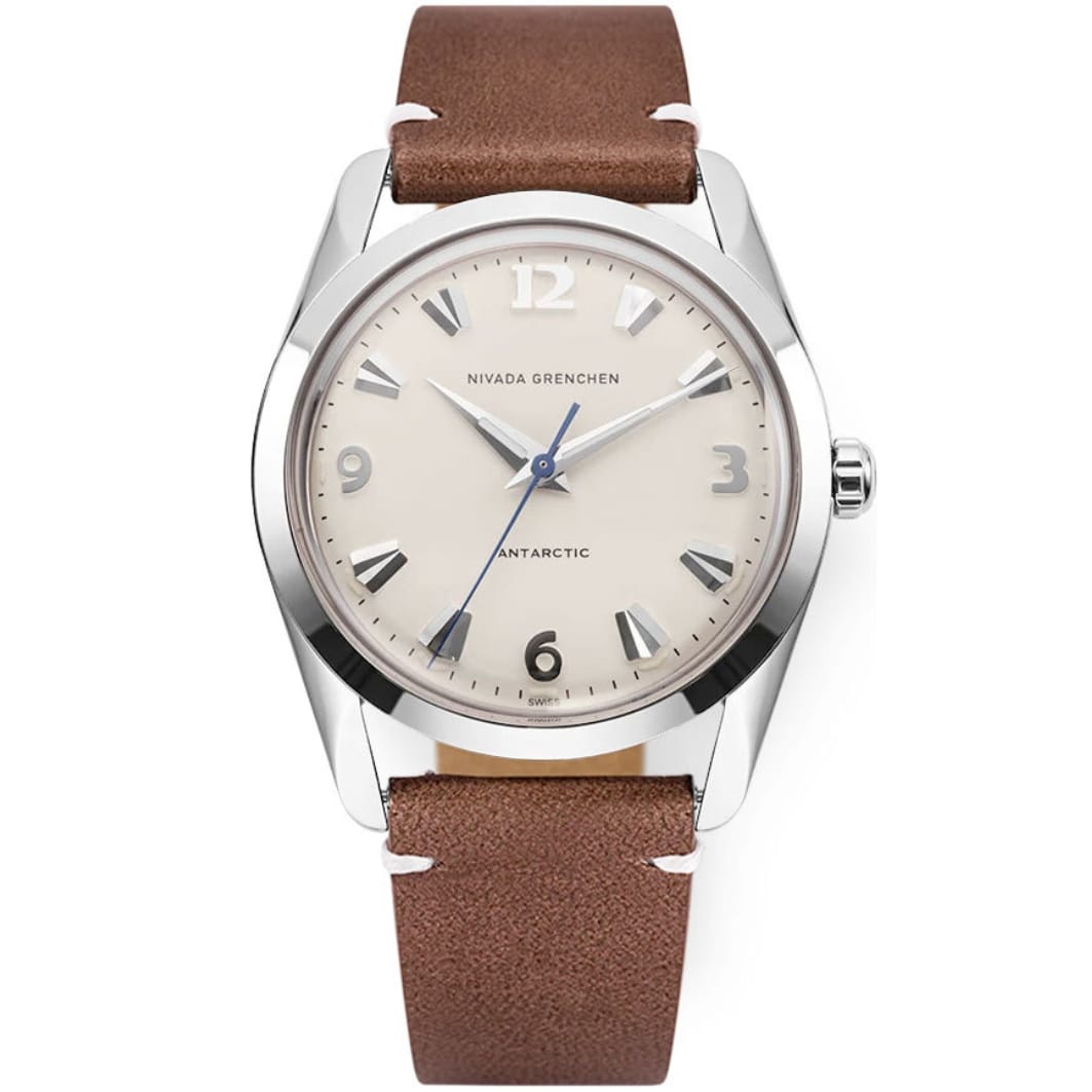 A silver wristwatch inspired by the iconic Nivada Grenchen Antarctic, featuring a beige dial, brown leather strap, and silver hour markers and hands. Model: 35004M14.