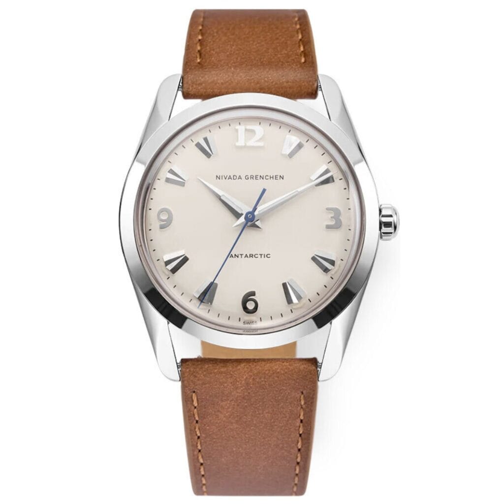 A silver Nivada Grenchen Antarctic 35004M16 watch with a beige face and brown leather strap.