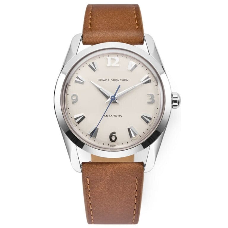 A silver Nivada Grenchen Antarctic 35004M16 watch with a beige face and brown leather strap.
