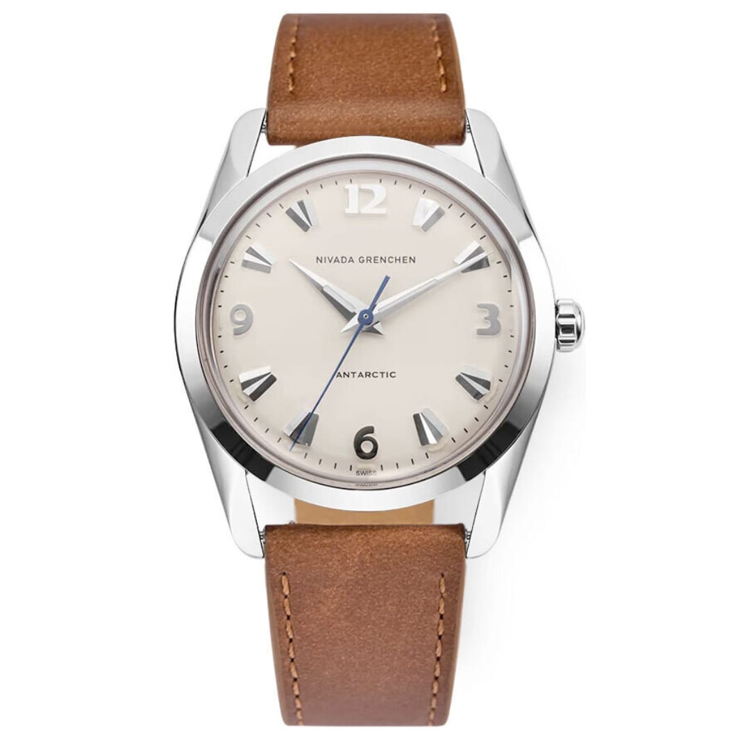 A silver Nivada Grenchen Antarctic 35004M16 watch with a beige face and brown leather strap.