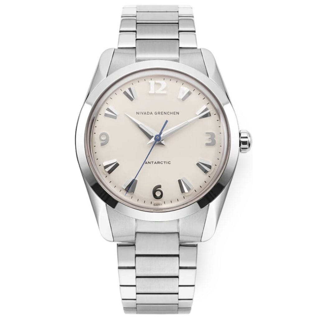 A silver Nivada Grenchen Antarctic wristwatch with a cream dial, silver markers, and a metal link band, showing the time as 7:23:07.