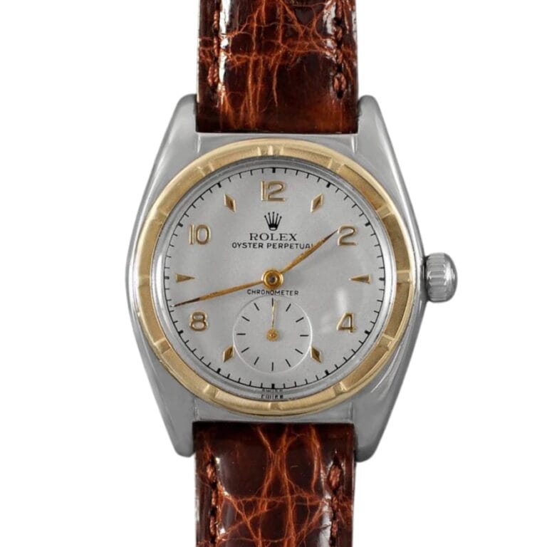 Vintage Rolex Oyster Perpetual 5013 watch with a brown leather strap and a silver dial featuring elegant gold accents.