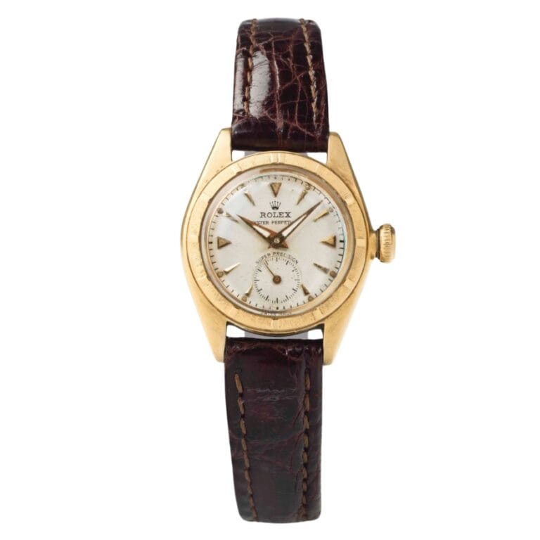A vintage Rolex Oyster Perpetual 5003 wristwatch with a brown leather strap and gold case on a white background.