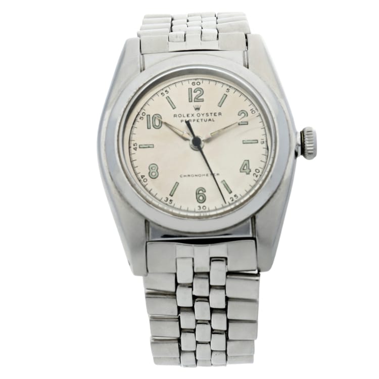 A vintage silver Rolex Oyster Perpetual wristwatch, reference 3940, featuring a white dial and classic metal bracelet.