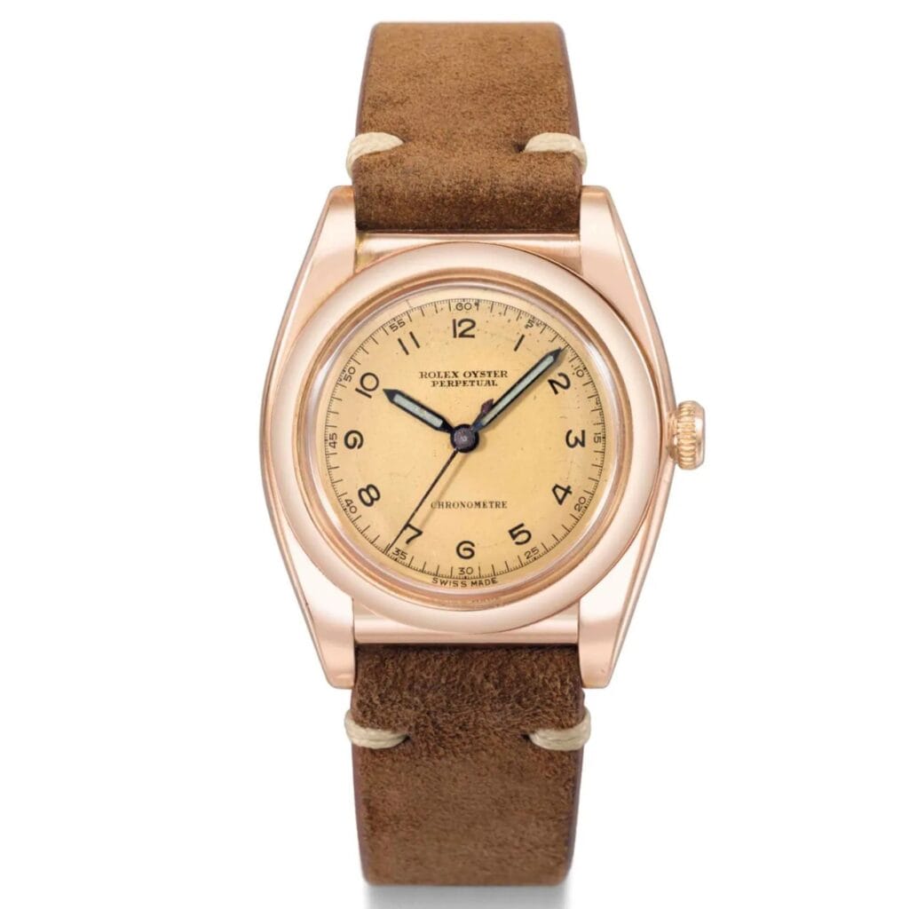 Vintage Rolex Oyster Perpetual watch, model 3696, with a tan dial and brown leather strap, shown from the front.