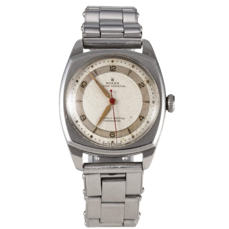 A vintage Rolex Oyster Perpetual wristwatch with a round white dial, silver case, and metal link bracelet. Model 4961.