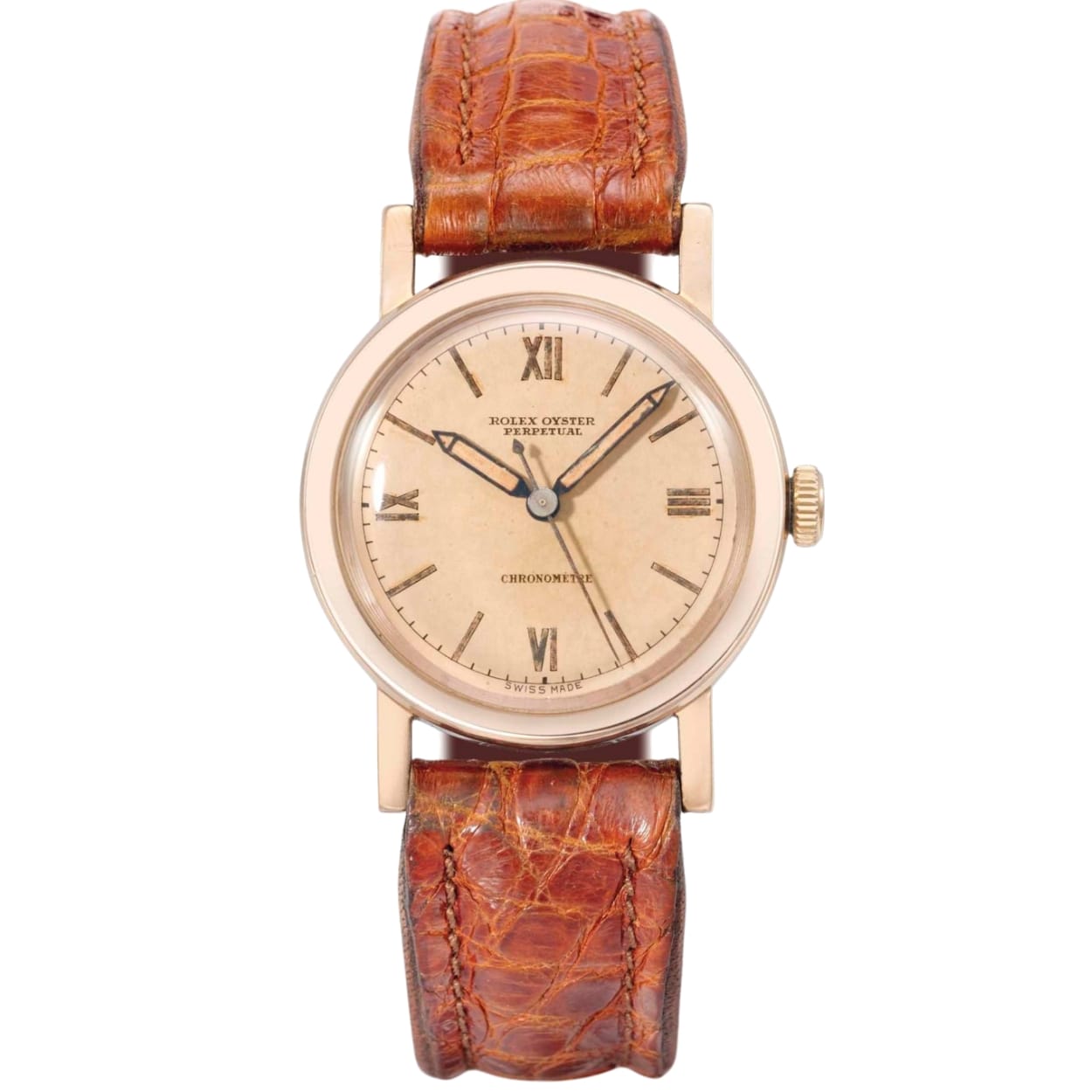 A vintage Rolex Oyster Perpetual wristwatch with a brown leather strap and a beige dial displaying Roman numerals.