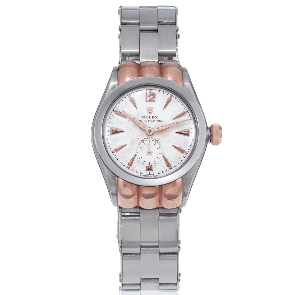 A silver and rose gold Rolex Oyster Perpetual wristwatch, model 3353, with a white face and a sleek metal bracelet.