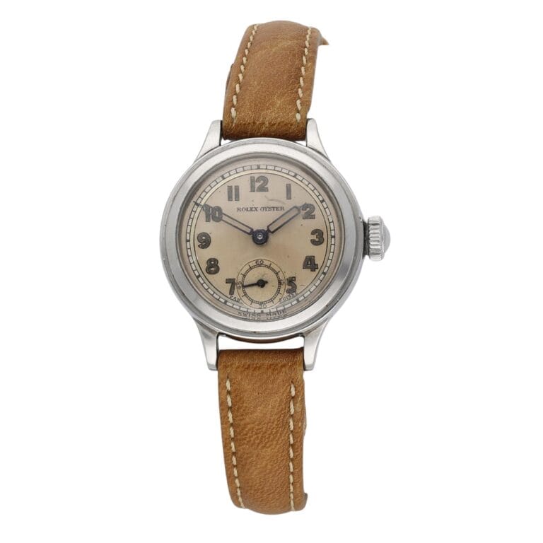 A vintage Rolex Oyster wristwatch with a tan leather strap and beige dial displaying Arabic numerals.