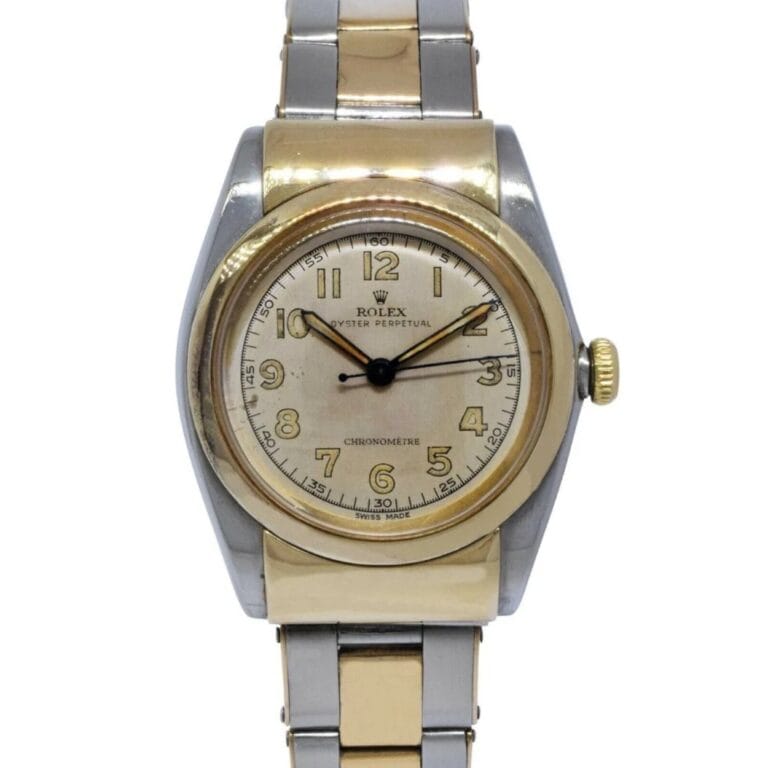 A two-tone Rolex Oyster Perpetual wristwatch with a silver and gold band, featuring a round face that displays gold numbers and hands.