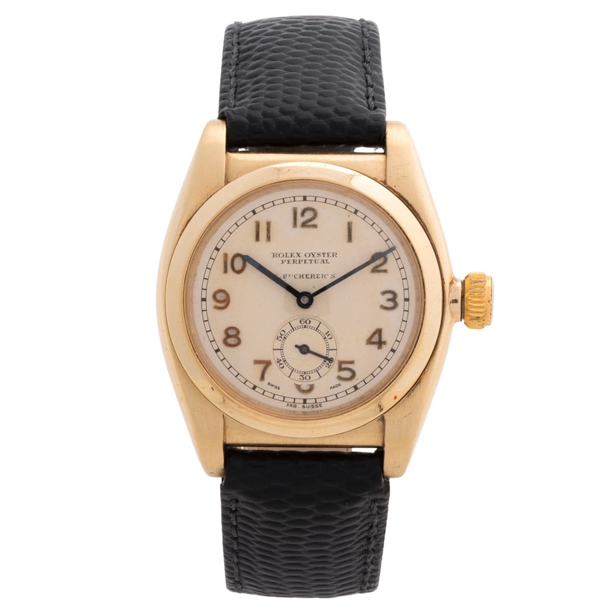 Vintage Rolex Oyster Perpetual wristwatch with a gold case, cream dial, and black textured leather strap.