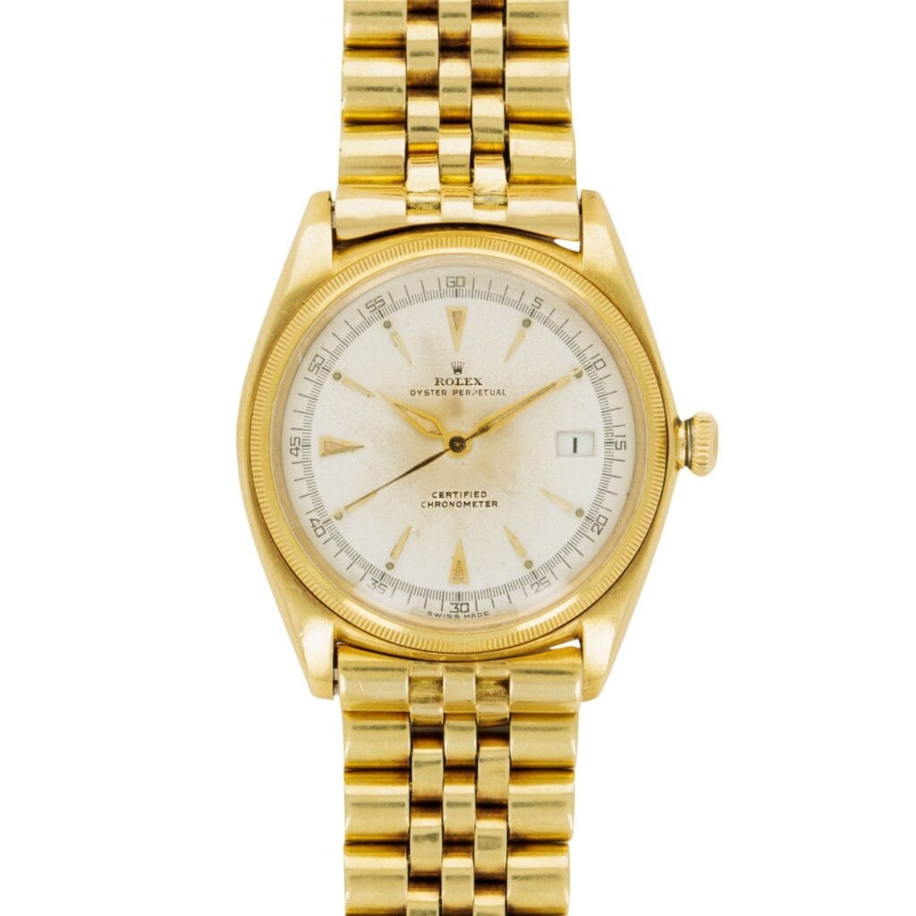 Gold Rolex Datejust 4467 wristwatch with a white dial, date window, and linked gold bracelet, viewed from above.