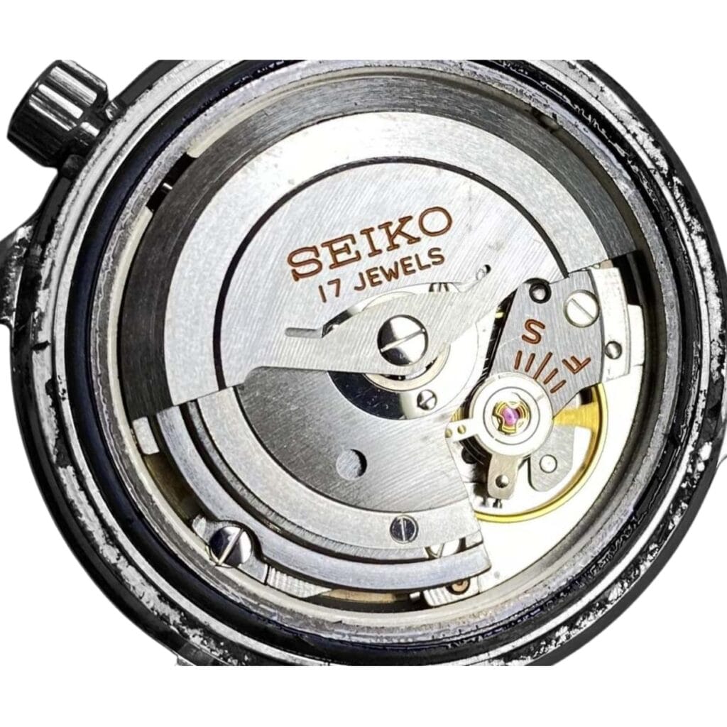 Close-up of a Seiko watch movement, showing gears and “SEIKO 17 JEWELS” engraved on the mechanism.