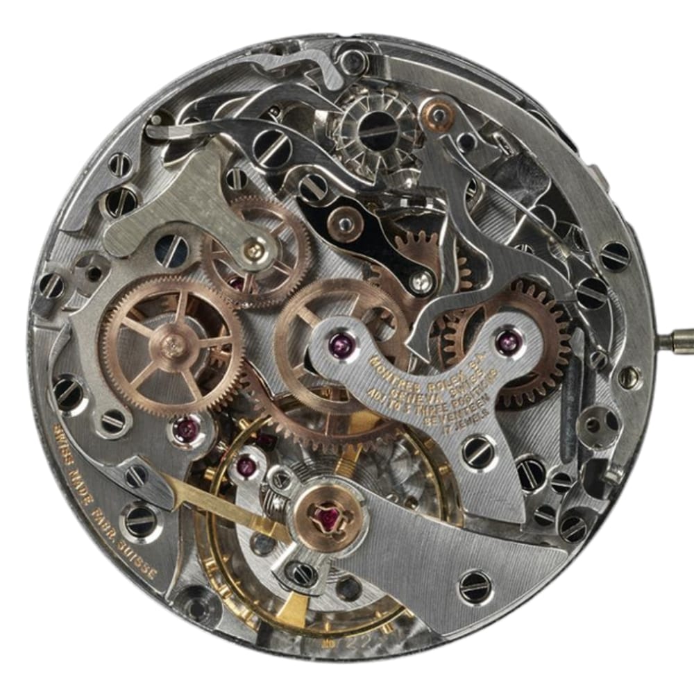 Close-up of intricate watch movement showing gears, cogs, and metallic components in a circular arrangement.