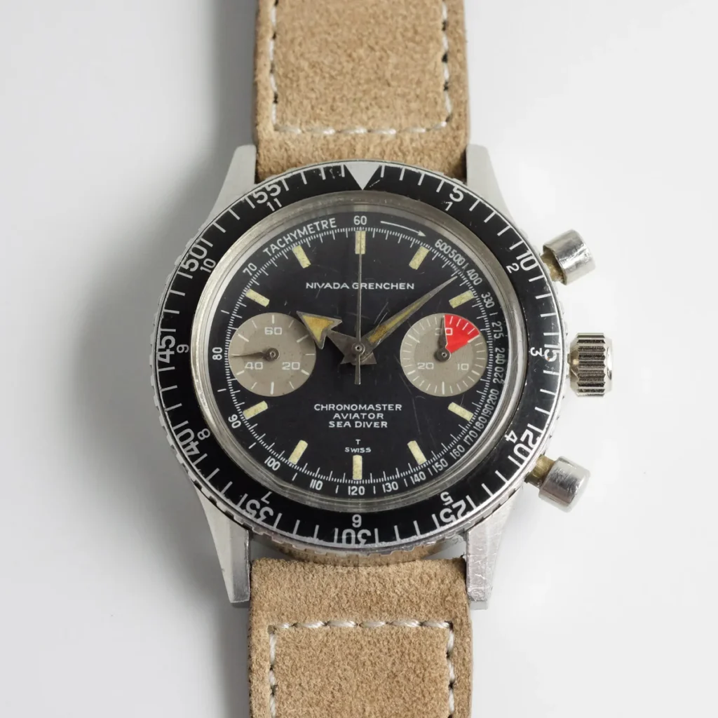 A vintage Nivada Grenchen Chronomaster Aviator Sea Diver chronograph wristwatch with a tan leather strap on a white background.