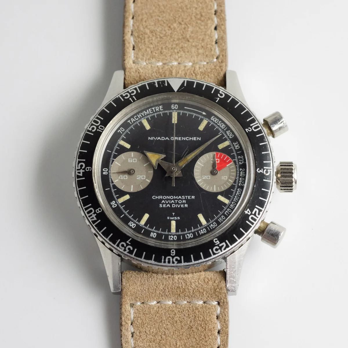 A vintage Nivada Grenchen Chronomaster Aviator Sea Diver chronograph wristwatch with a tan leather strap on a white background.