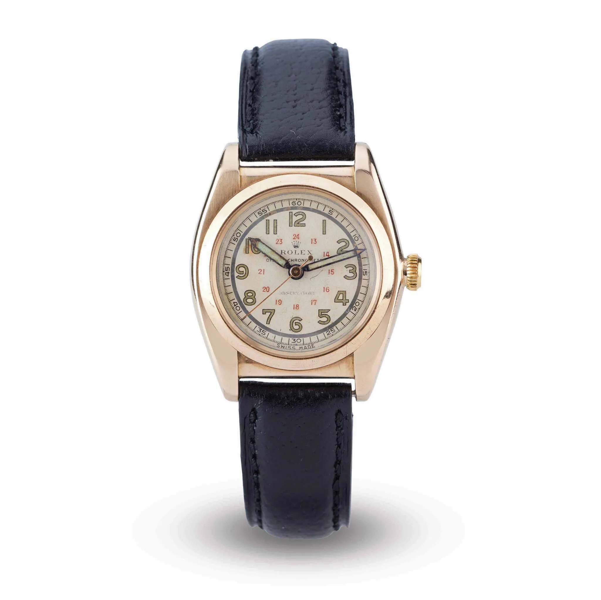 A gold Rolex Oyster 3009 wristwatch with a black leather strap and a white dial displaying both 12 and 24 hour markers.