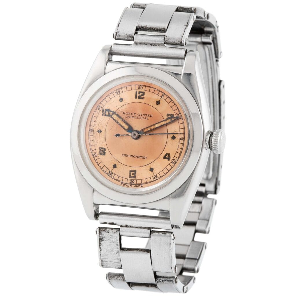 A vintage Rolex Oyster Perpetual 3134 watch with a salmon dial and stainless steel bracelet.