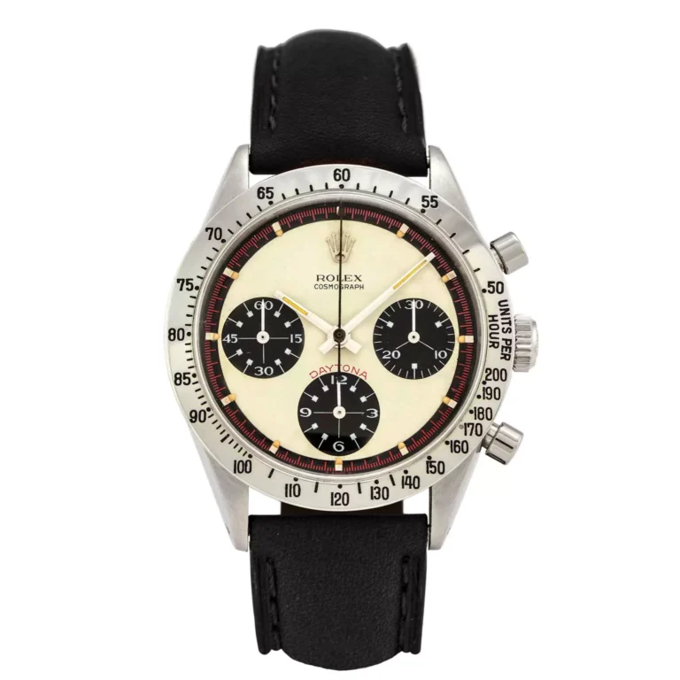 The Rolex Cosmograph Daytona 6239 features a black leather strap and three black subdials on a striking white face.
