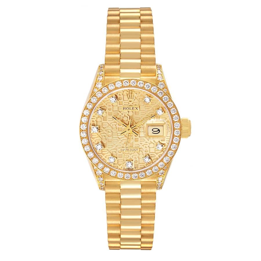 Gold Rolex Datejust 69158 watch with diamond bezel, patterned face, and date display on a gold link bracelet.