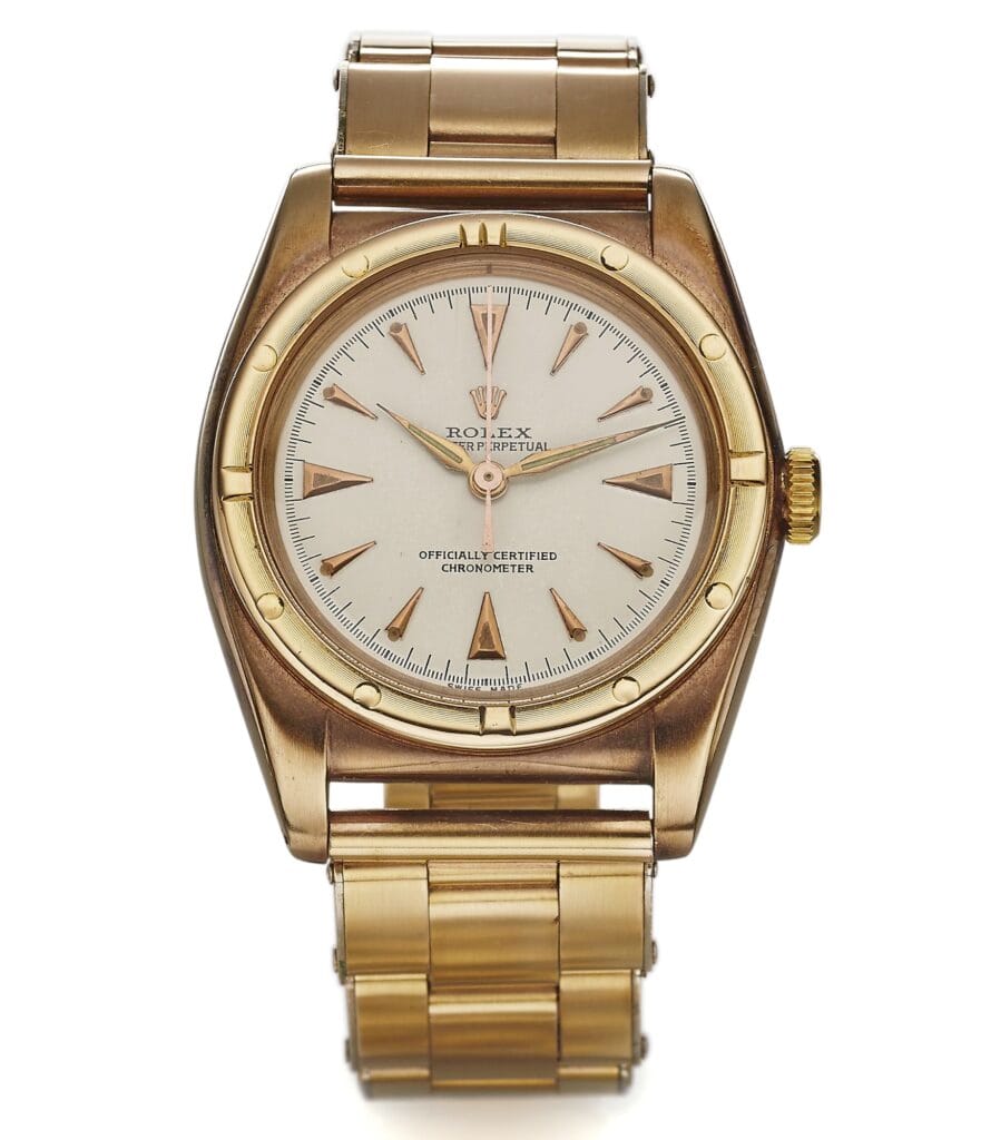 Gold Rolex Oyster Perpetual wristwatch, model 3725, featuring a round face, gold hour markers, and a classic metal link band.