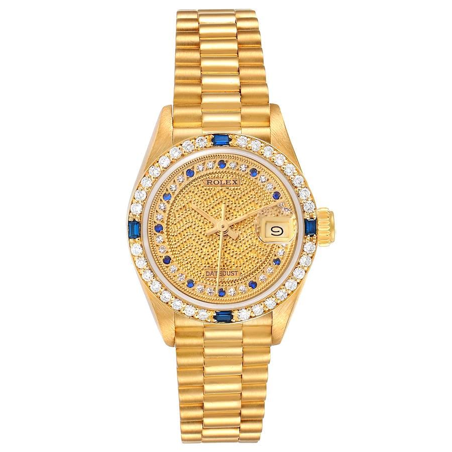 Luxury watch featuring a gold Rolex Datejust 69088 with diamond and blue gemstone bezel, patterned gold dial, and elegant metal link bracelet.