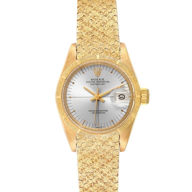 Gold Rolex Datejust 6900 watch with a silver dial and textured gold bracelet, displaying the date at 3 o’clock.