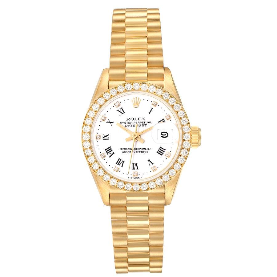 Gold Rolex Datejust 69138 with diamond bezel, white dial, and Roman numerals on a gold link bracelet.