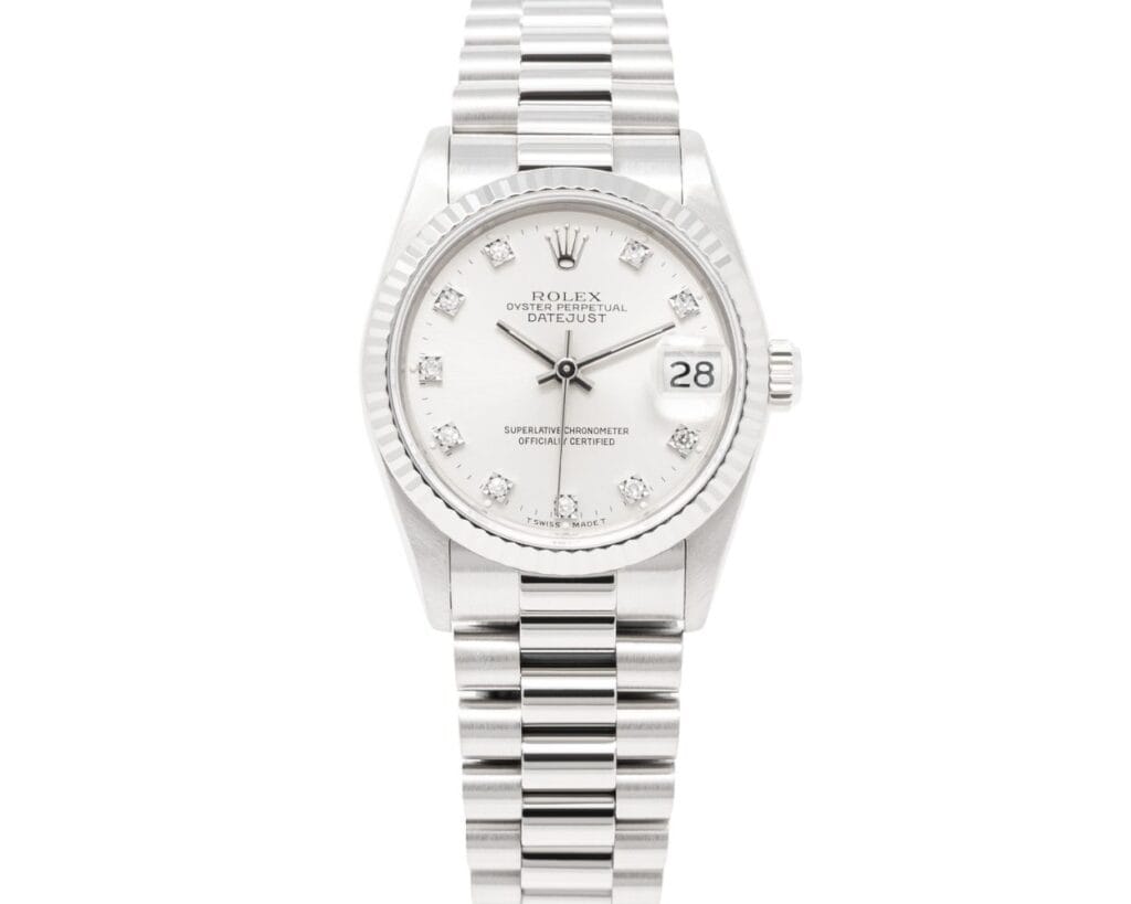 A silver Rolex Datejust 68279 watch with a white dial, diamond hour markers, and a metal link bracelet.