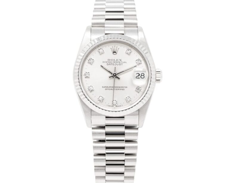 A silver Rolex Datejust 68279 watch with a white dial, diamond hour markers, and a metal link bracelet.