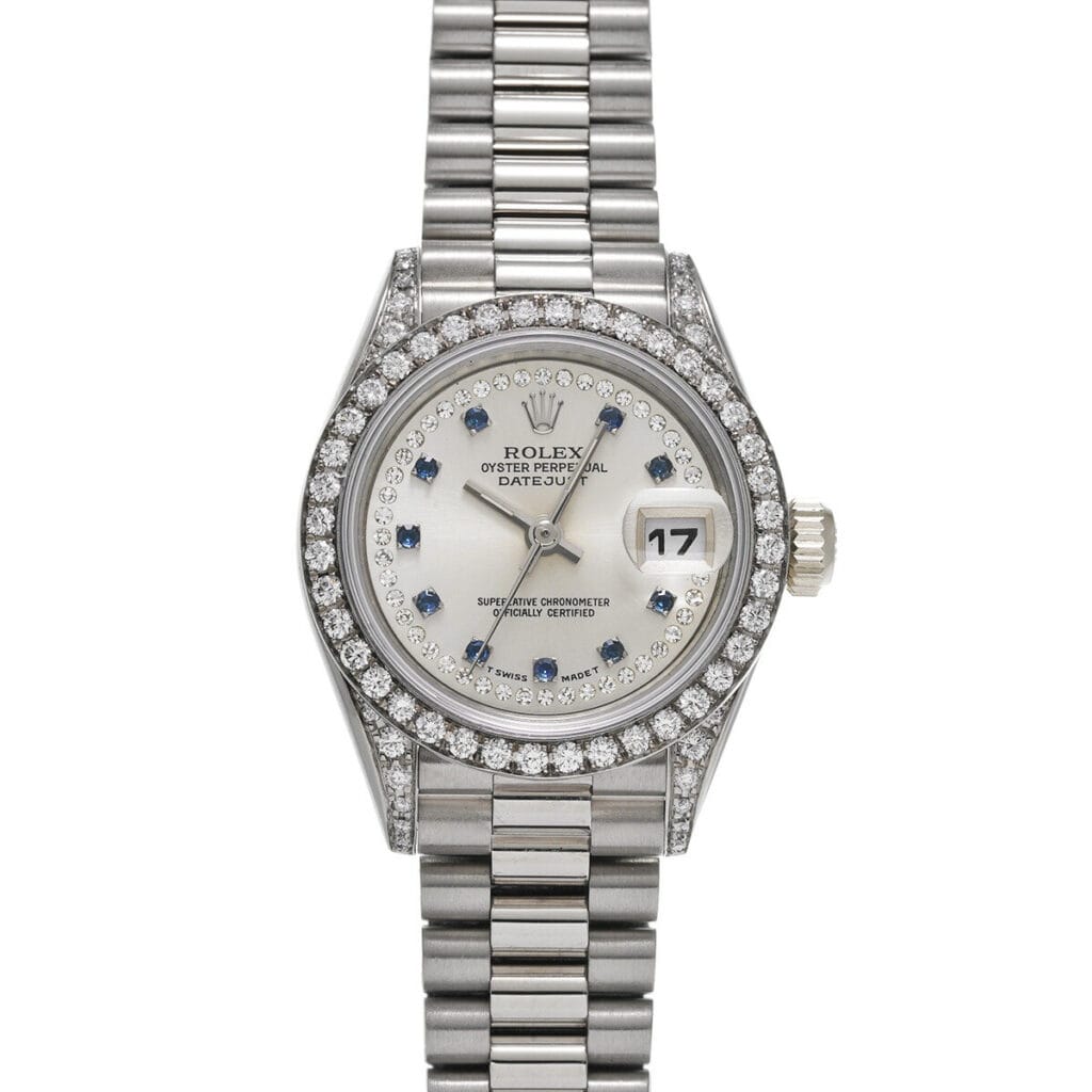 A silver Rolex Datejust luxury watch featuring a diamond bezel, sapphire markers, and a stainless steel bracelet, this stunning Rolex 69159 exudes timeless elegance.
