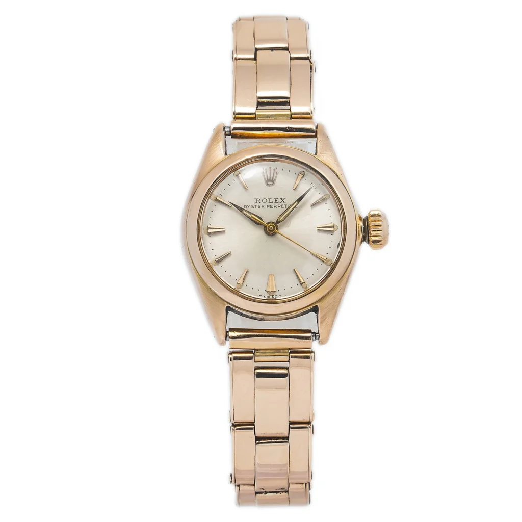 A gold Rolex Oyster Perpetual wristwatch with a round face and metal link band, elegantly displaying the time at 10:10.