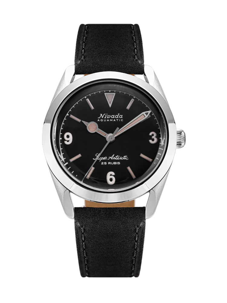 A black Nivada Grenchen Super Antarctic wristwatch with a round face, silver markers, and a black leather strap. Model: 32032A17.