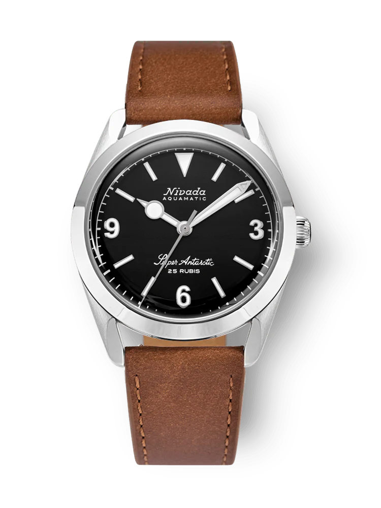 A classic Nivada Grenchen Super Antarctic wristwatch with a black dial, silver case, and brown leather strap.