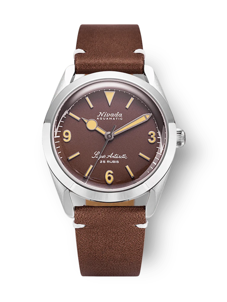 Brown vintage-style Nivada Grenchen Super Antarctic wristwatch with a leather strap and silver casing, displaying 3, 6, 9, and 12 numerals. Model: 32041A14.