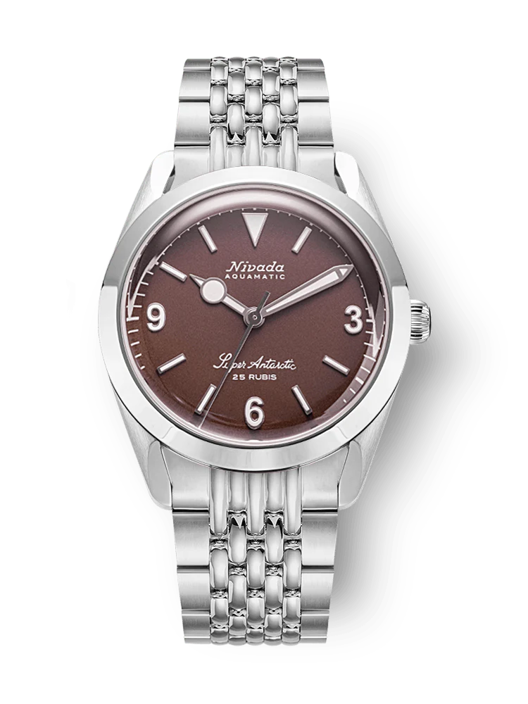 The Nivada Grenchen Super Antarctic 32040A04 is a silver wristwatch featuring a brown dial, silver hour markers, and a sleek metal link bracelet.