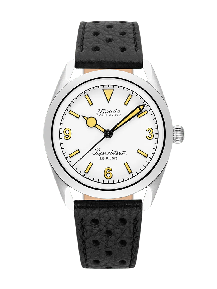 Silver Nivada Grenchen Super Antarctic automatic wristwatch with a white dial, yellow markers, and a black perforated strap.