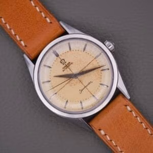 Omega Seamaster 2802-4 SC wrist-angle on tan leather strap, cream waffle dial with cross-hair printing and dauphine hands.