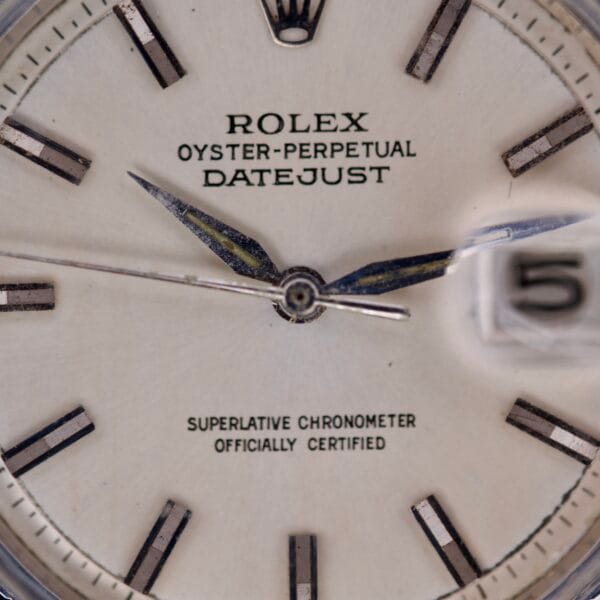 Close-up of the Rolex Datejust 1603 Silver Dial with distinctive Alpha hands, featuring a clear watch face and magnified date window.