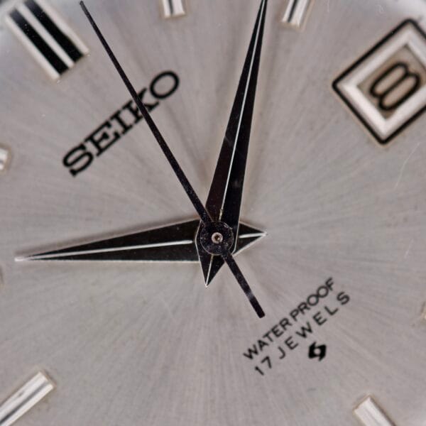 Close-up of a Seiko 6602-8040 Manual Wind Date Sunburst Dial, highlighting the sunburst dial, hands, and Water Proof 17 Jewels text.