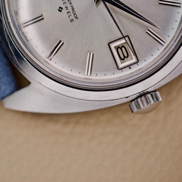 Close-up of the Seiko 6602-8040 Manual Wind Date Sunburst Dial wristwatch, displaying the date as 8 and the time at approximately 1:05.