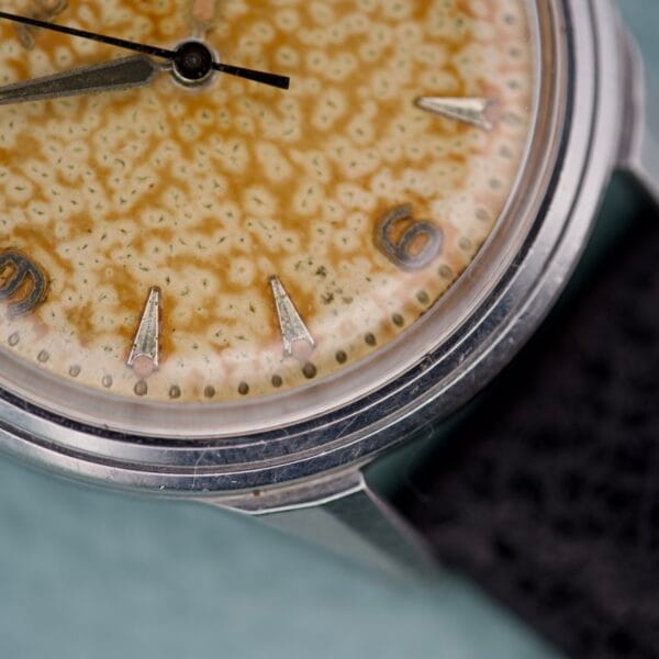 Close-up of the Movado Caltrava Ref. 18271 Tropic Dial Stainless Steel watch, showcasing a speckled yellow aged dial with silver markers at 3, 6, and 9.