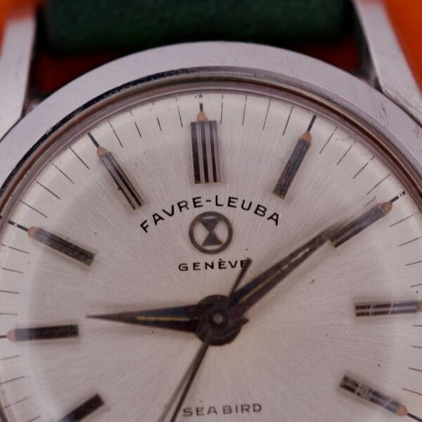 Close-up of a vintage Favre Leuba Geneve Seabird Alarm wristwatch, showcasing its stainless steel case and detailed dial with intricate watch hands.