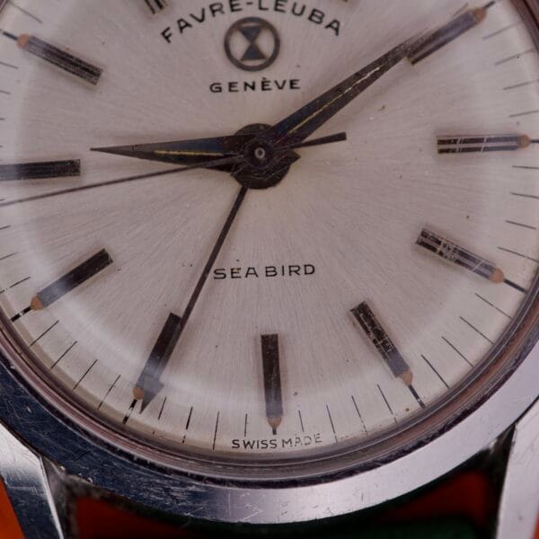 Close-up of a vintage Favre Leuba Geneve Seabird Alarm Stainless Steel wristwatch, showcasing the dial and watch hands.