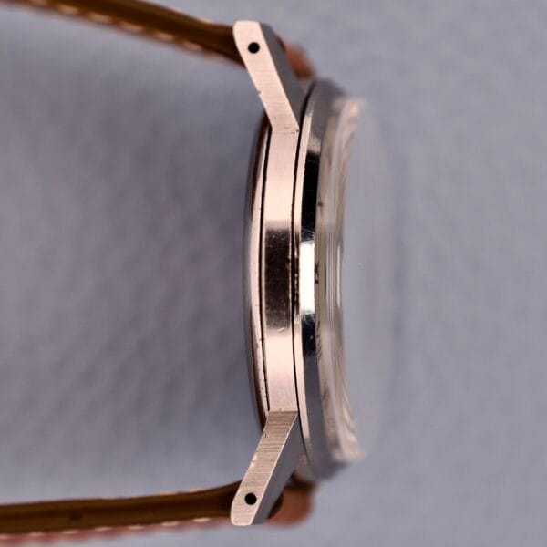 Side view of the Omega Ref. 2271-2 Jumbo Stainless Steel Case 30T2 with a brown leather strap, showcasing the watch lugs, crystal, and iconic 30T2 movement.