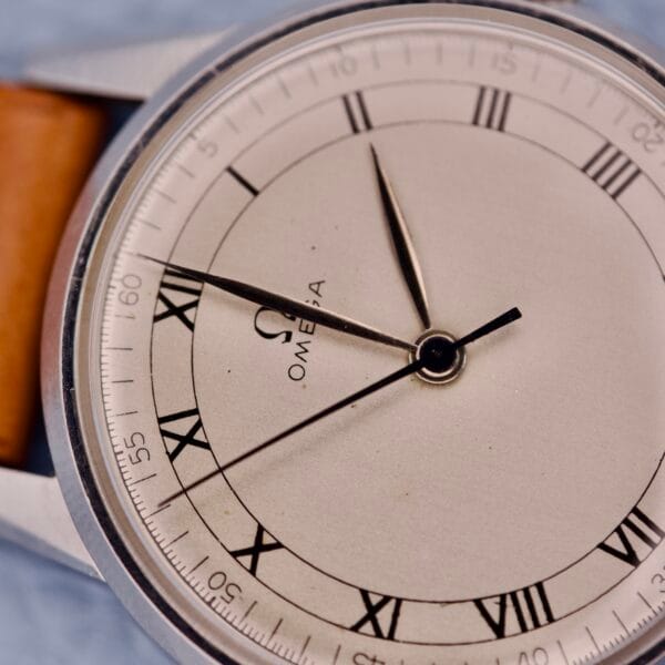 Close-up of the Omega Ref. 2271-2 Jumbo Stainless Steel Case 30T2 wristwatch featuring Roman numerals and a brown leather strap.