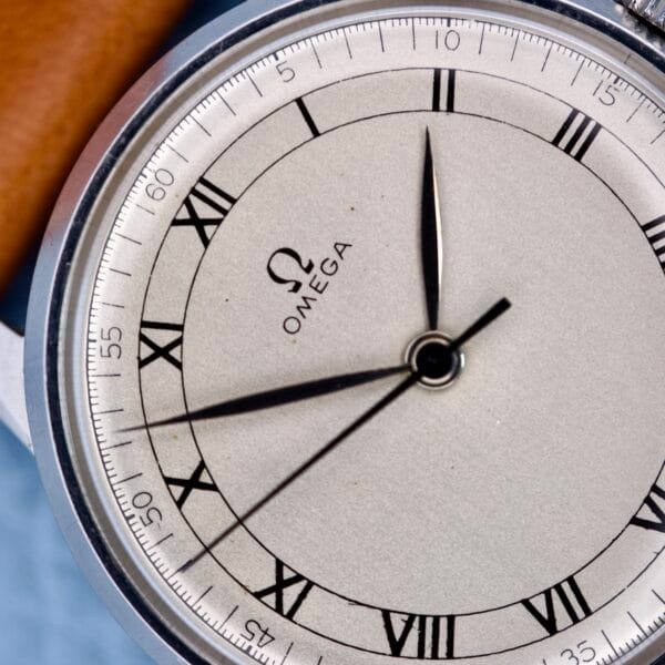 Close-up of an Omega Ref. 2271-2 Jumbo Stainless Steel Case 30T2 watch face with Roman numerals and black hands showing 8:00:28, highlighting its classic design.